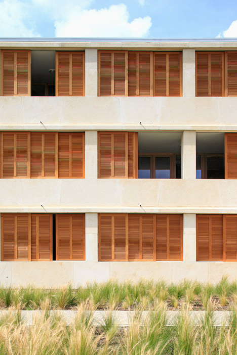 Social housing with solid stone walls by Perraudin Architecture