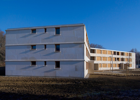 Social housing with solid stone walls by Perraudin Architecture