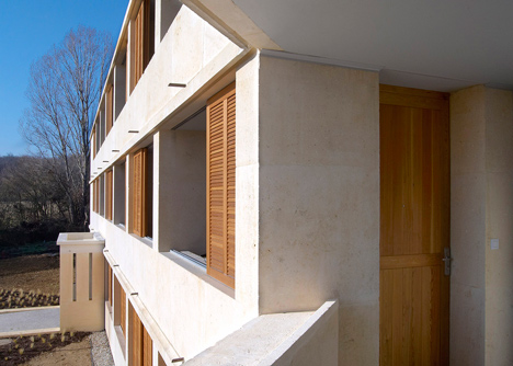 Social housing with solid stone walls by Perraudin Architecture