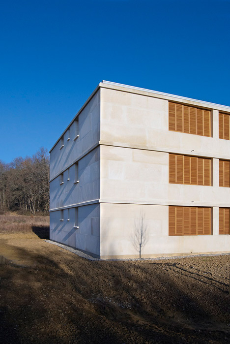 Social housing with solid stone walls by Perraudin Architecture