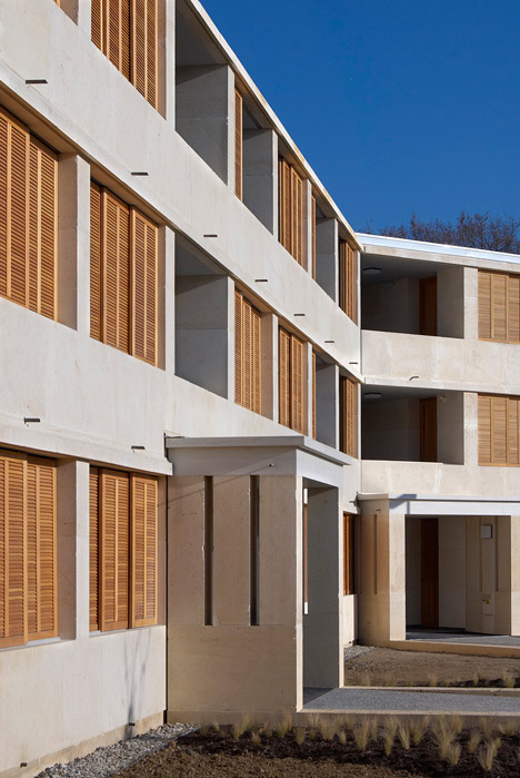 Social housing with solid stone walls by Perraudin Architecture