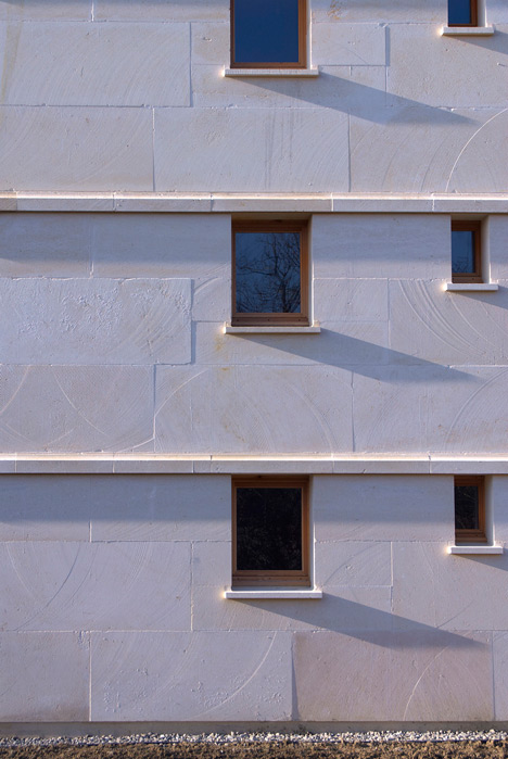 Social housing with solid stone walls by Perraudin Architecture