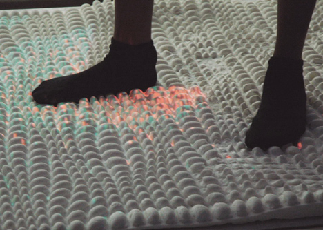 Surfaces that use hacked bacteria to detect dirt or clean themselves