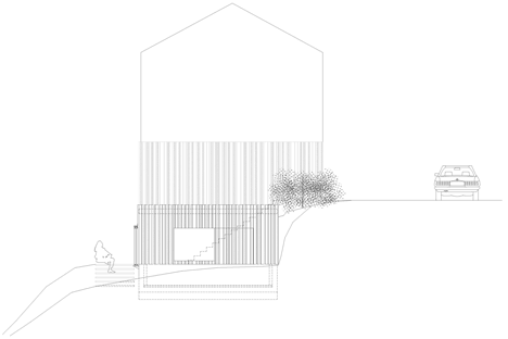 Blackened timber house extension with textured walls by Marchi Architectes