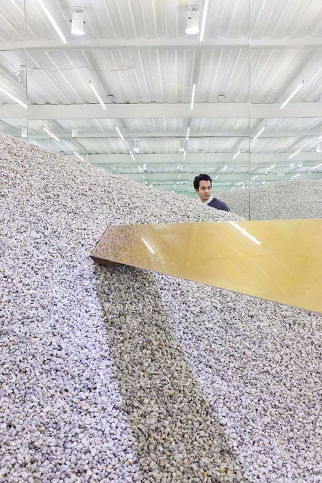 Golden girders protrude from piles of gravel to display sunglasses