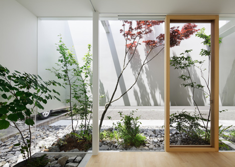 Green Edge House by mA-style Architects encases a perimeter garden behind its walls 