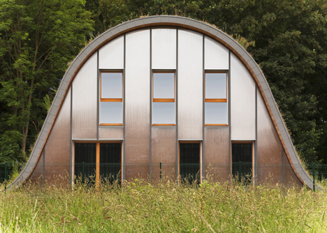 Hump-shaped house blanketed by plants by Patrick Nadeau