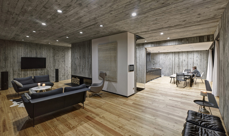 Timber-clad seaside house with a grainy concrete interior by Ultra Architects