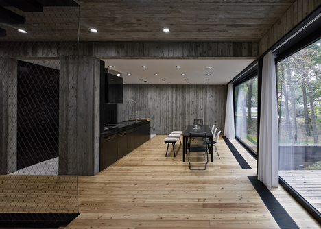Timber-clad seaside house with a grainy concrete interior by Ultra Architects