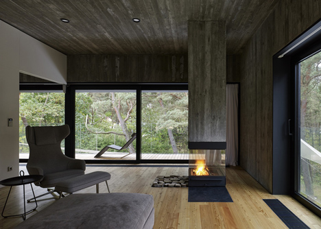 Timber-clad seaside house with a grainy concrete interior by Ultra Architects