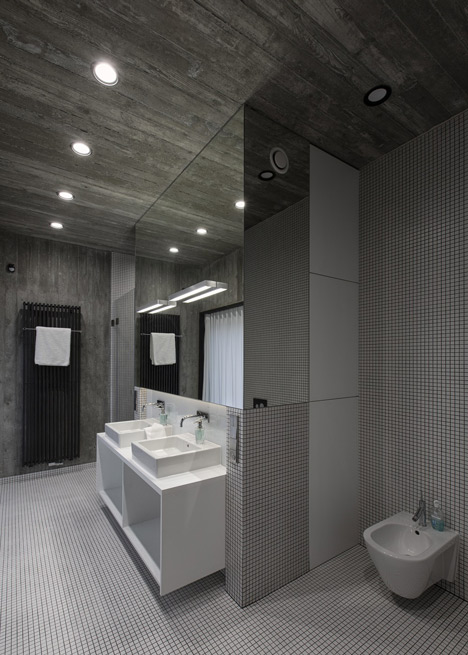 Timber-clad seaside house with a grainy concrete interior by Ultra Architects