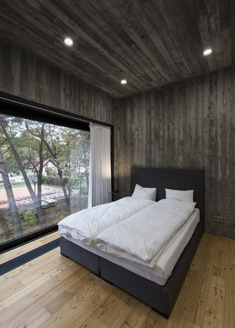 Timber-clad seaside house with a grainy concrete interior by Ultra Architects