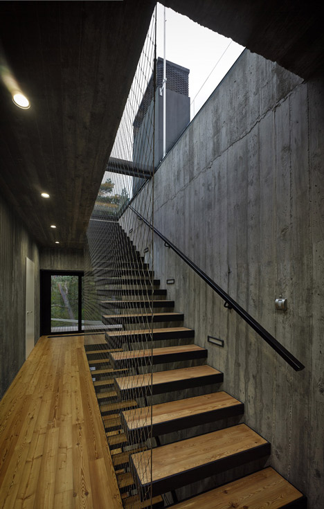 Timber-clad seaside house with a grainy concrete interior by Ultra Architects
