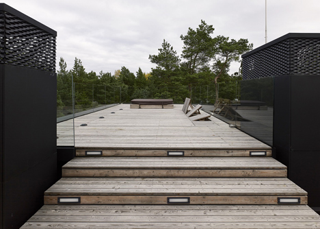Timber-clad seaside house with a grainy concrete interior by Ultra Architects