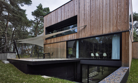 Timber-clad seaside house with a grainy concrete interior by Ultra Architects