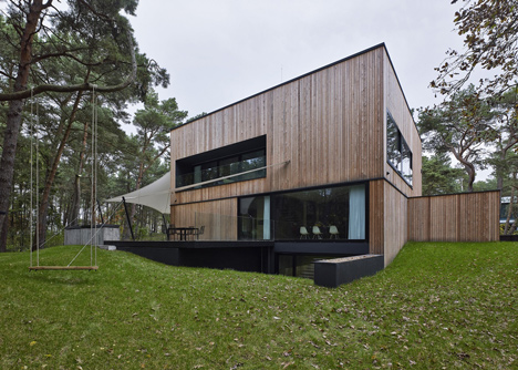 Timber-clad seaside house with a grainy concrete interior by Ultra Architects