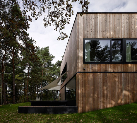 Timber-clad seaside house with a grainy concrete interior by Ultra Architects