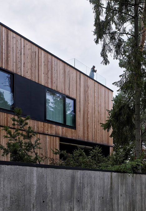 Timber-clad seaside house with a grainy concrete interior by Ultra Architects