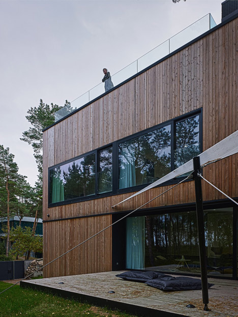 Timber-clad seaside house with a grainy concrete interior by Ultra Architects