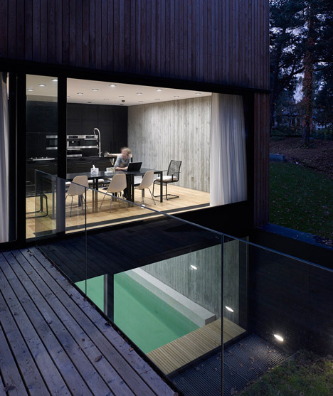 Timber-clad seaside house with a grainy concrete interior by Ultra Architects