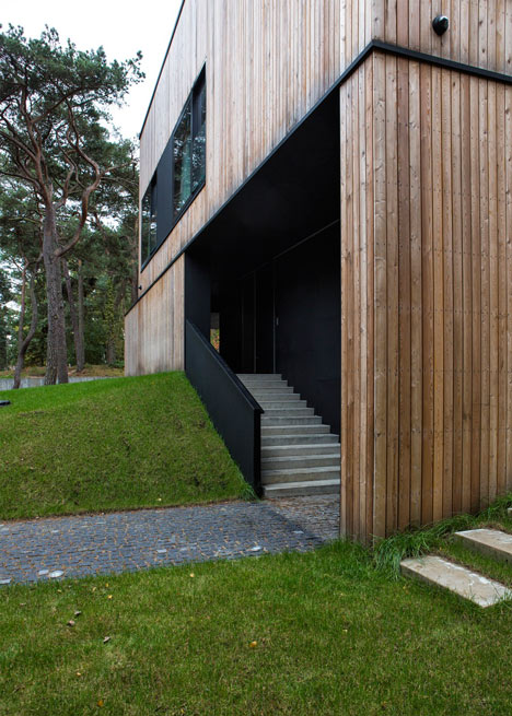 Timber-clad seaside house with a grainy concrete interior by Ultra Architects