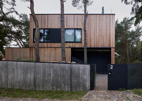 Timber-clad seaside house with a grainy concrete interior by Ultra Architects