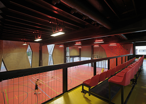Concrete-clad sports hall by Idis Turato with both faceted and bumpy facades