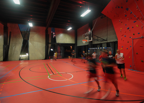 Concrete-clad sports hall by Idis Turato with both faceted and bumpy facades