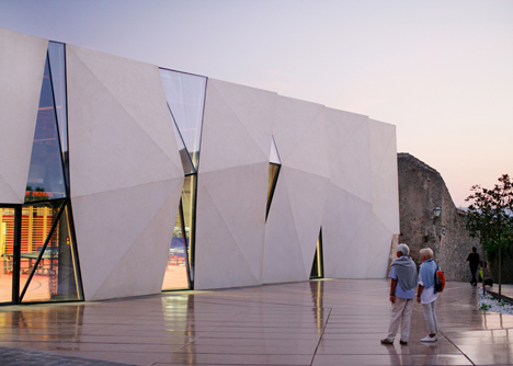 Concrete-clad sports hall by Idis Turato with both faceted and bumpy facades