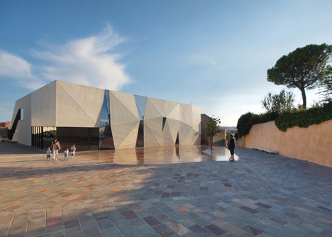 Concrete-clad sports hall by Idis Turato with both faceted and bumpy facades