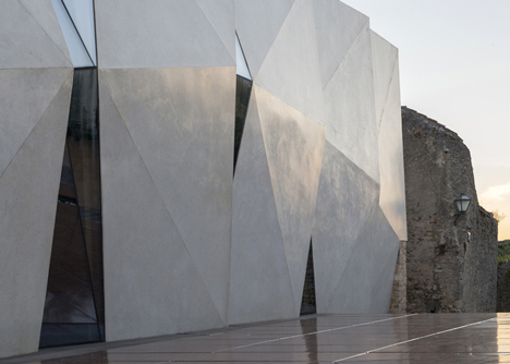 Concrete-clad sports hall by Idis Turato with both faceted and bumpy facades
