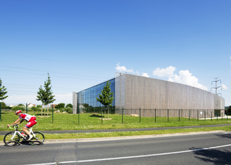 Sports centre clad with sun-bleached wooden slats by Explorations Architecture