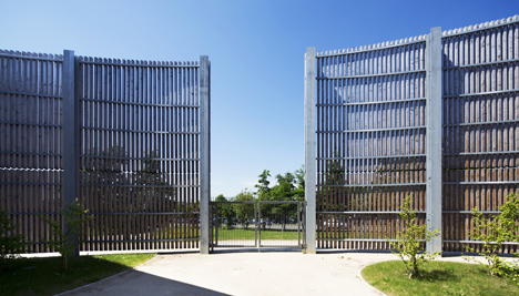 Sports centre clad with sun-bleached wooden slats by Explorations Architecture