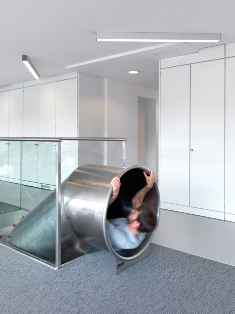 The Workshop offices with a slide through the centre by Guy Holloway