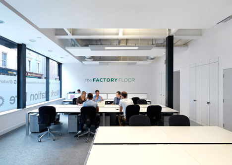 The Workshop offices with a slide through the centre by Guy Holloway