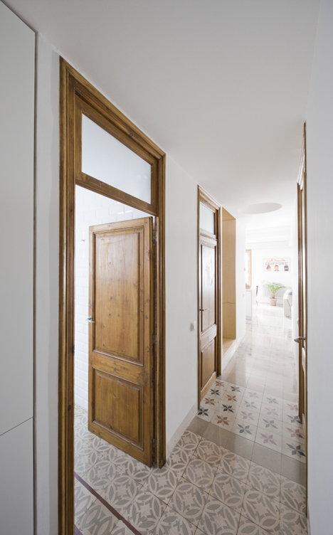 Barcelona apartment by Bach Arquitectes with colourful floor tiles arranged in stripes