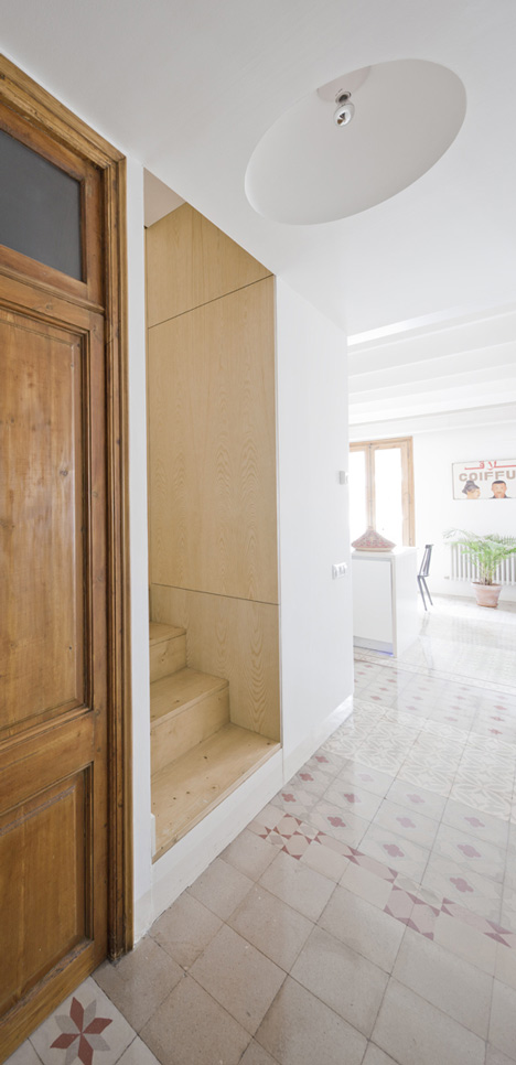 Barcelona apartment by Bach Arquitectes with colourful floor tiles arranged in stripes