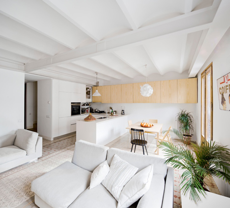 Barcelona apartment by Bach Arquitectes with colourful floor tiles arranged in stripes