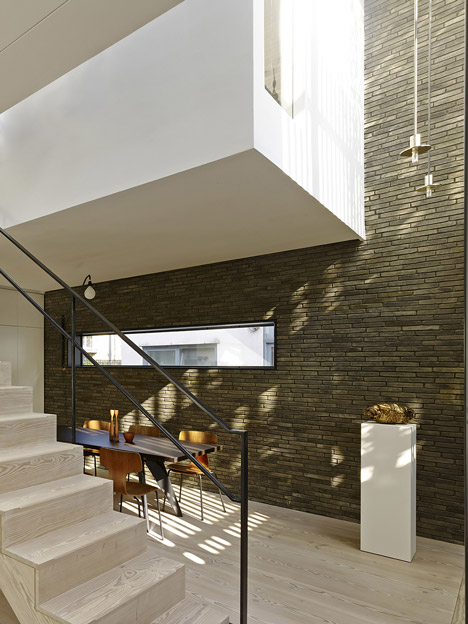 Blackbox mews house by Form_art Architects has brick walls that continue inside