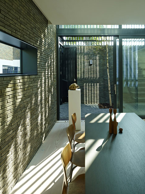 Blackbox mews house by Form_art Architects has brick walls that continue inside