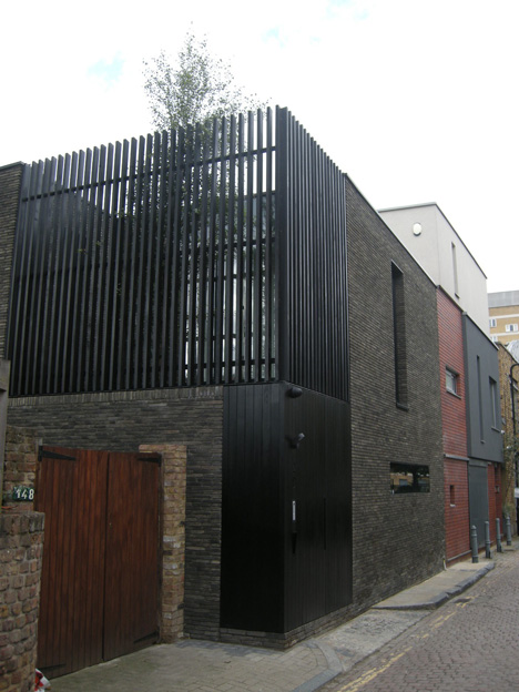 Blackbox mews house by Form_art Architects has brick walls that continue inside