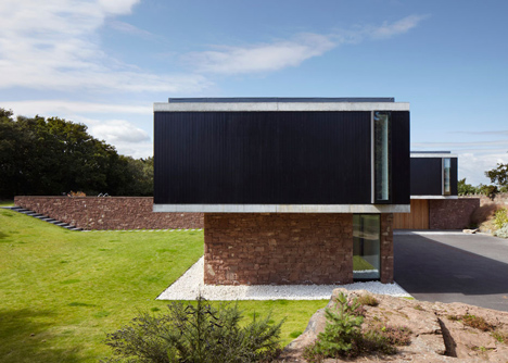 Coastal concrete house on a red sandstone base by ShedKM