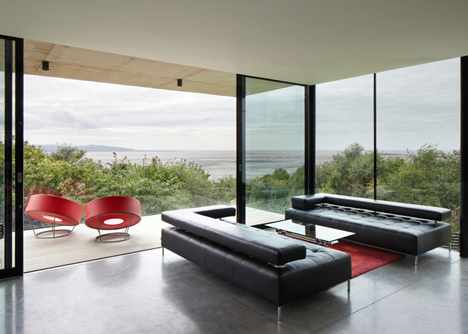 Coastal concrete house on a red sandstone base by ShedKM