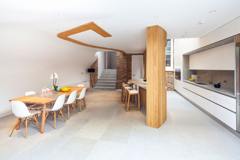 Curvy timber extension by Scott Architects features a sloping grass roof