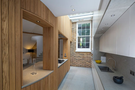 Curvy timber extension by Scott Architects features a sloping grass roof