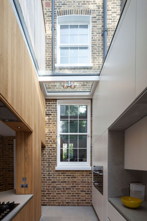 Curvy timber extension by Scott Architects features a sloping grass roof