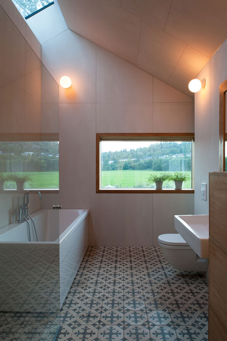 Double-gabled house overlooking a Norwegian fjord by Schjelderup Trondahl Architects
