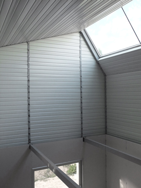 M03 house renovation by BAST contrasts old brick base with new metal extension