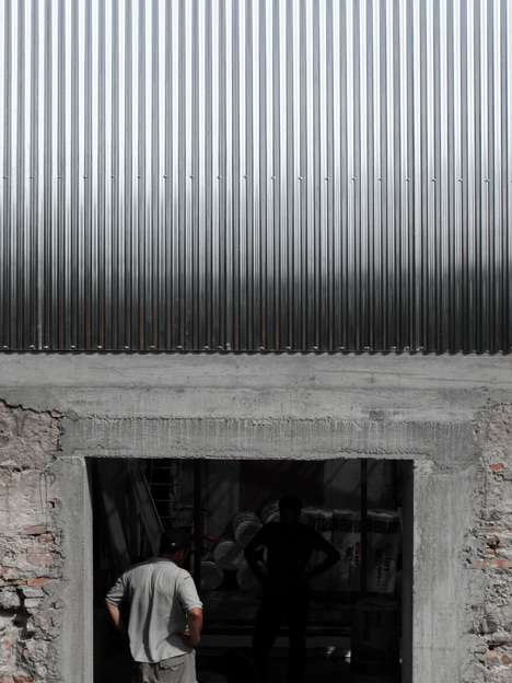 M03 house renovation by BAST contrasts old brick base with new metal extension