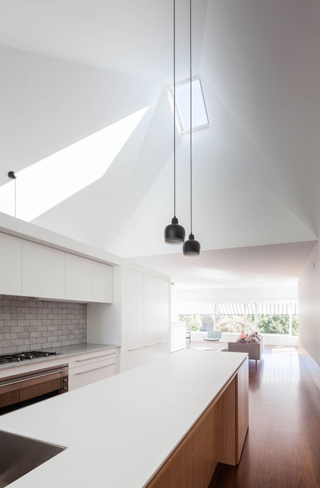 Renovated single-storey house with distorted ceiling voids by Tribe Studio